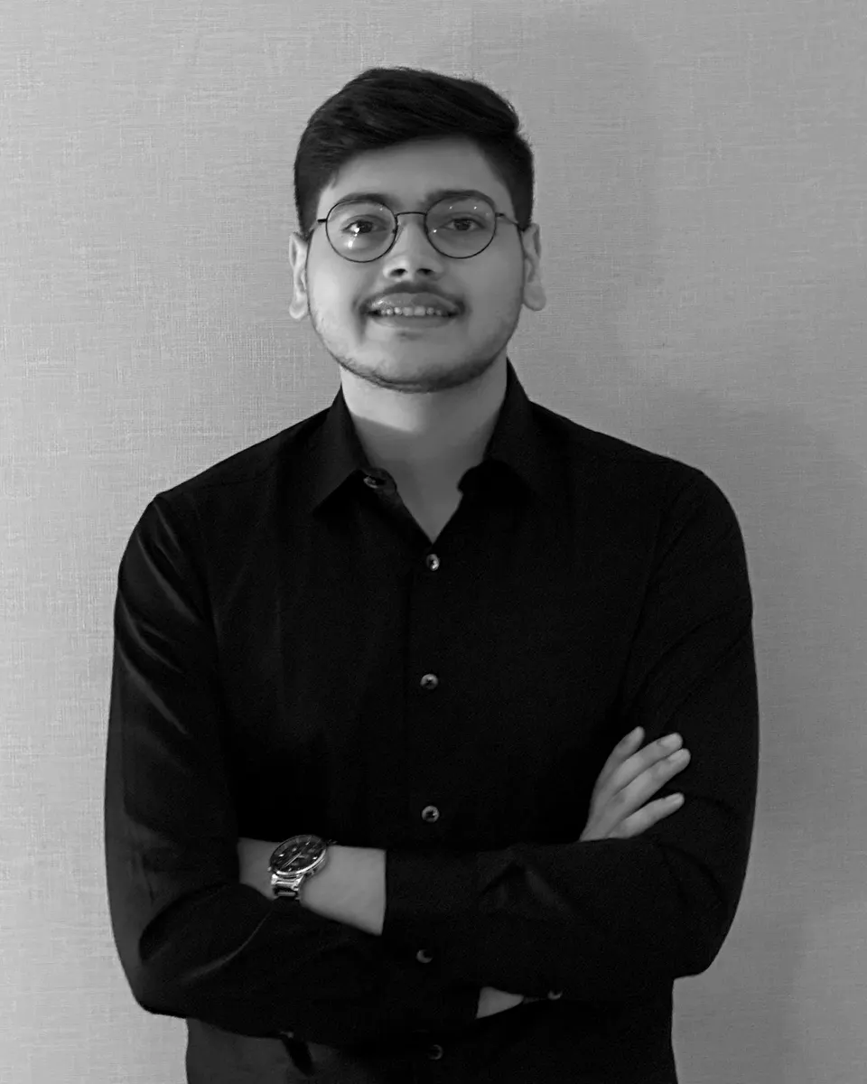 Pratham Panchal, arms crossed, in a black shirt